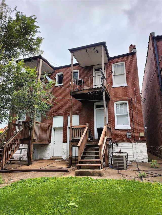 back of house featuring central AC