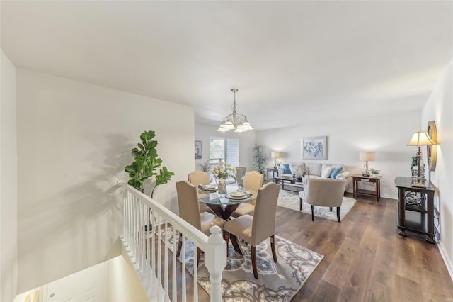 dining area featuring dark hardwood / wood-style floors and a chandelier