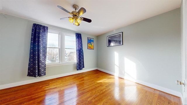 unfurnished room featuring hardwood / wood-style floors and ceiling fan