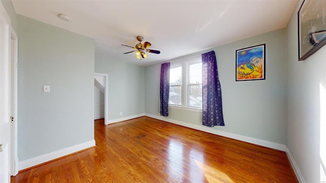 unfurnished room featuring ceiling fan and hardwood / wood-style floors