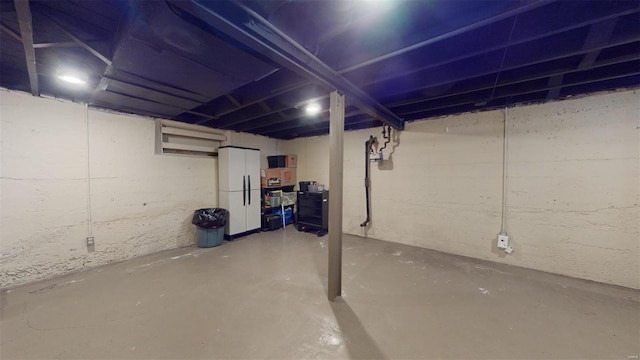 basement with white fridge