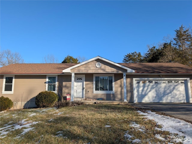 single story home featuring a yard and a garage