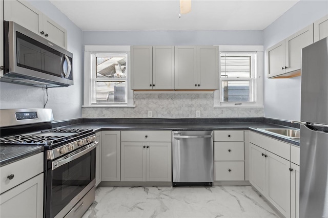 kitchen featuring sink, stainless steel appliances, and a healthy amount of sunlight