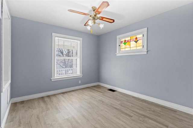 empty room featuring ceiling fan and light hardwood / wood-style flooring