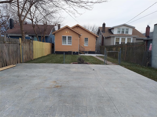 rear view of property with a lawn