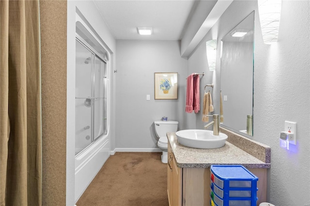 full bathroom featuring bath / shower combo with glass door, vanity, and toilet