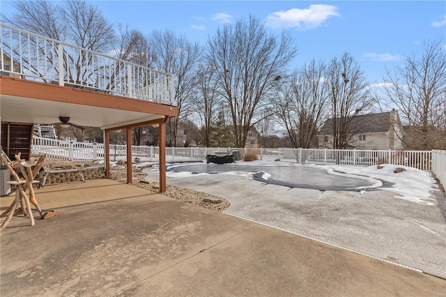 view of yard with a patio, a covered pool, and ceiling fan