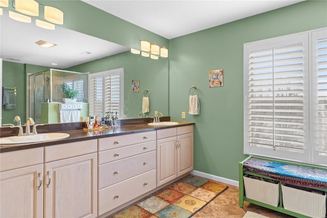 bathroom featuring vanity and a shower with shower door