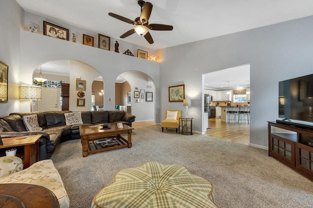 carpeted living room with ceiling fan