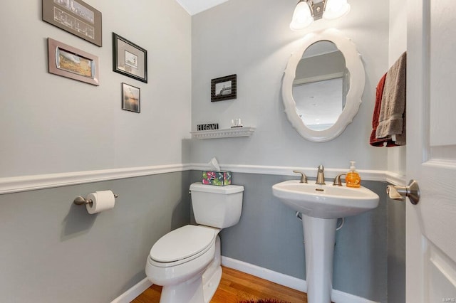 bathroom featuring sink, hardwood / wood-style flooring, and toilet