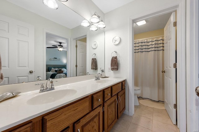 bathroom with vanity, toilet, and tile patterned flooring