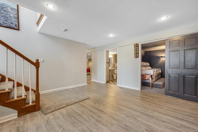 interior space featuring hardwood / wood-style floors and a textured ceiling