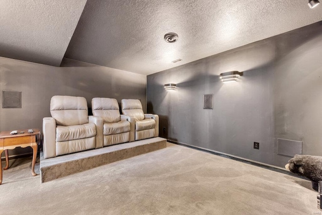 cinema featuring light carpet and a textured ceiling