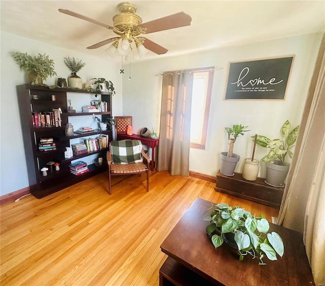 sitting room featuring wood-type flooring and ceiling fan