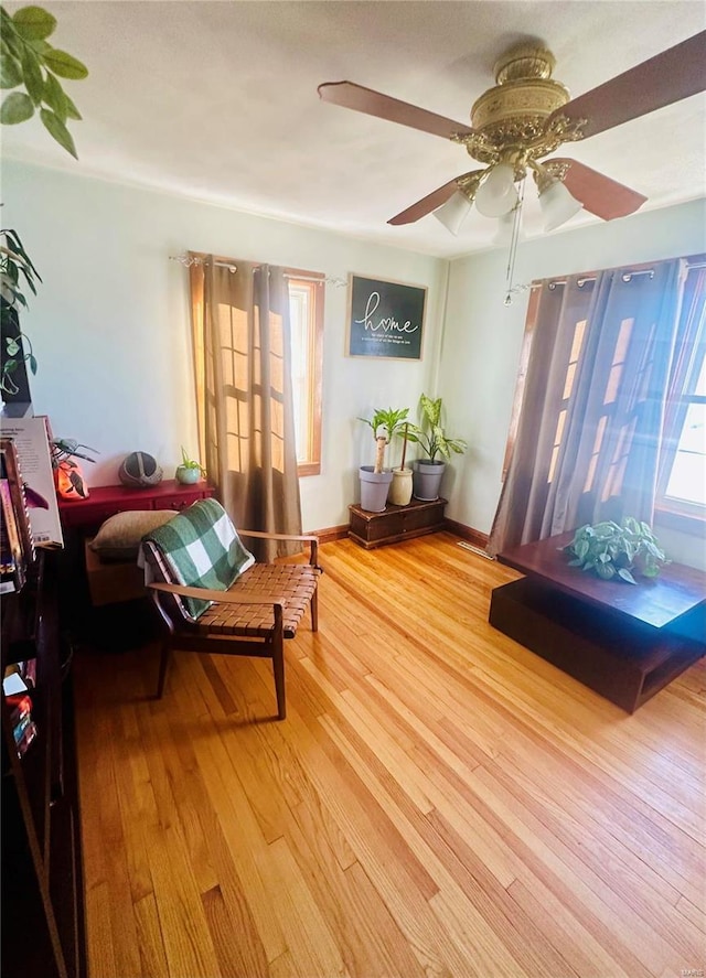 sitting room featuring hardwood / wood-style floors, a wealth of natural light, and ceiling fan