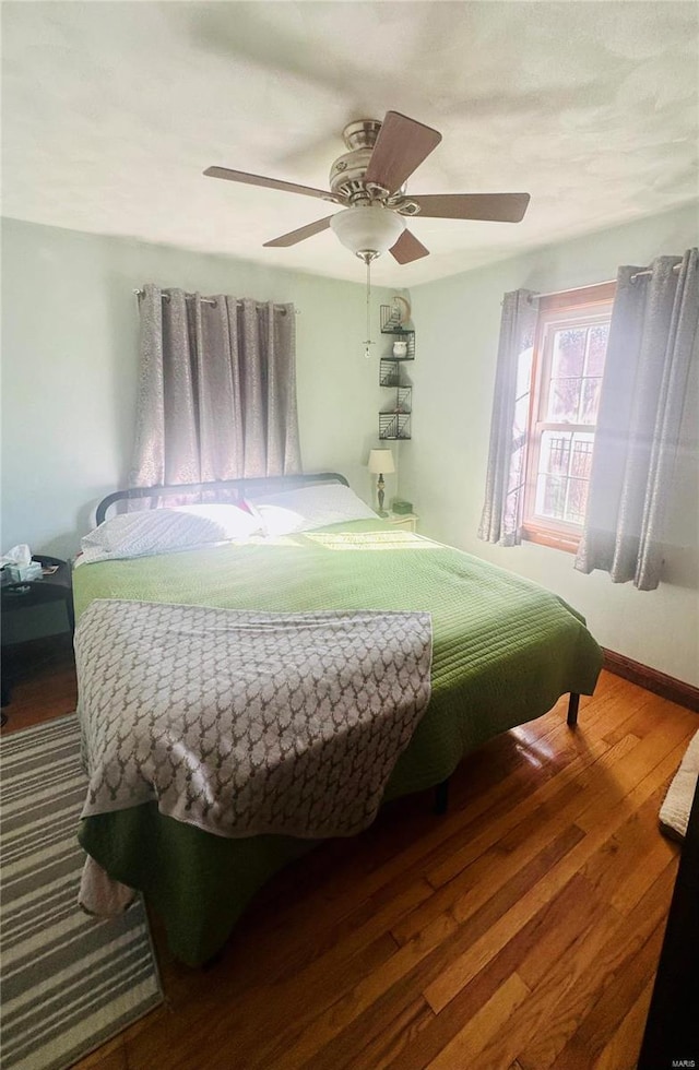 bedroom featuring hardwood / wood-style flooring and ceiling fan