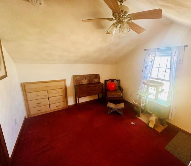 living area with vaulted ceiling, carpet floors, and ceiling fan