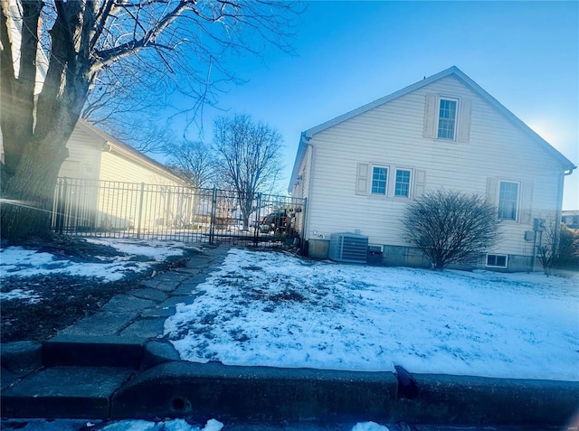 snow covered property featuring central air condition unit