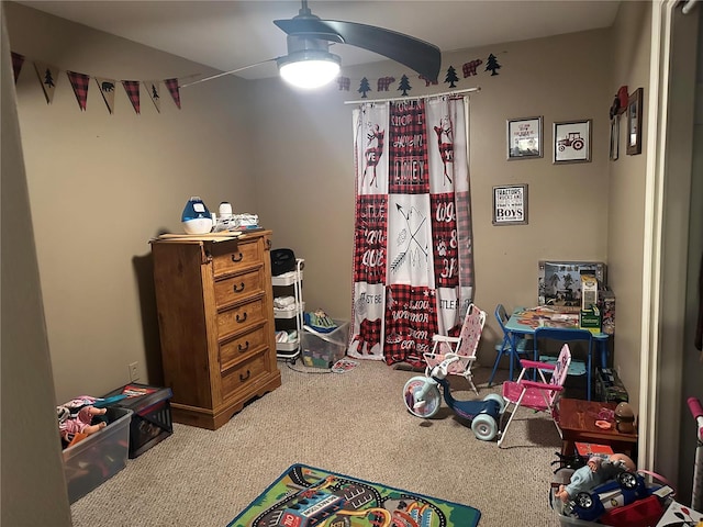 playroom with ceiling fan and carpet floors