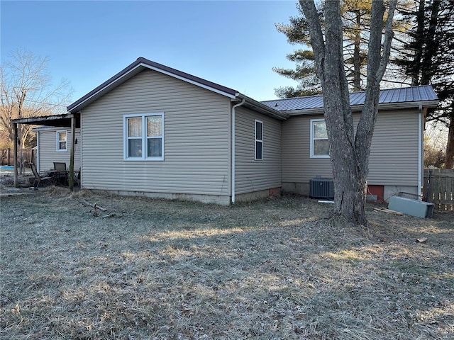 rear view of house featuring central AC unit