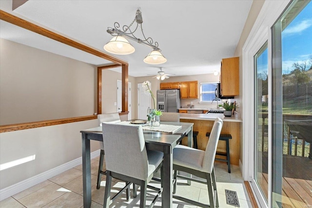 tiled dining room with ceiling fan