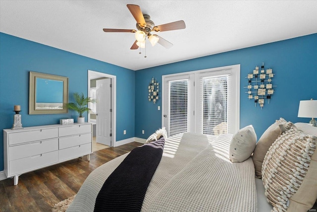 bedroom with dark hardwood / wood-style floors, ceiling fan, access to exterior, and a textured ceiling