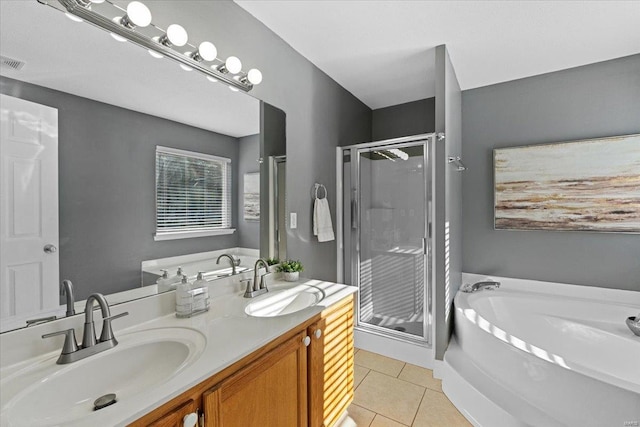 bathroom featuring tile patterned flooring, vanity, and separate shower and tub