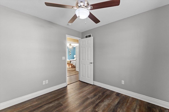 unfurnished bedroom with ceiling fan and dark hardwood / wood-style flooring