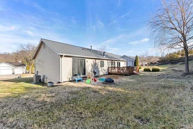 back of house featuring a wooden deck, cooling unit, and a lawn