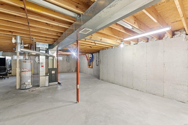 basement featuring heating unit and gas water heater