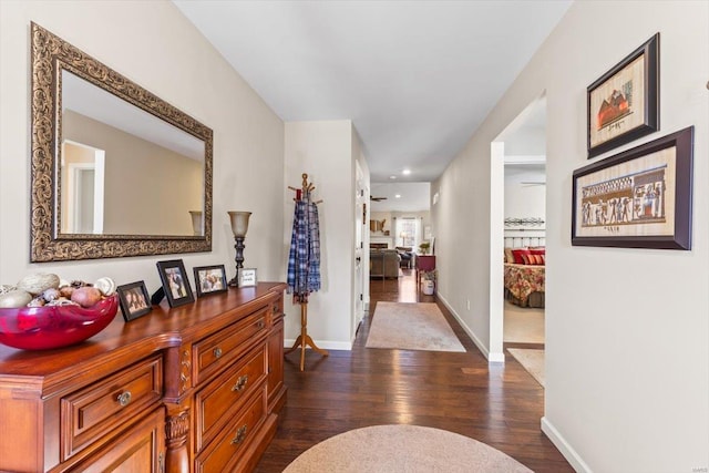 hallway with dark hardwood / wood-style flooring