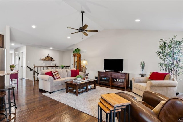 living room featuring dark wood-type flooring, ceiling fan, and vaulted ceiling