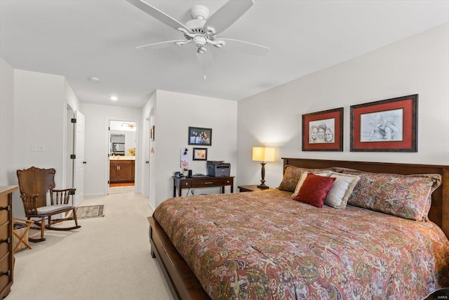 carpeted bedroom featuring ceiling fan and ensuite bath