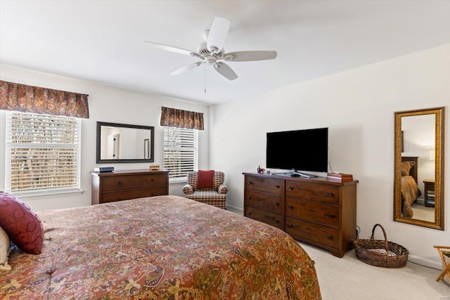 bedroom featuring light colored carpet and ceiling fan