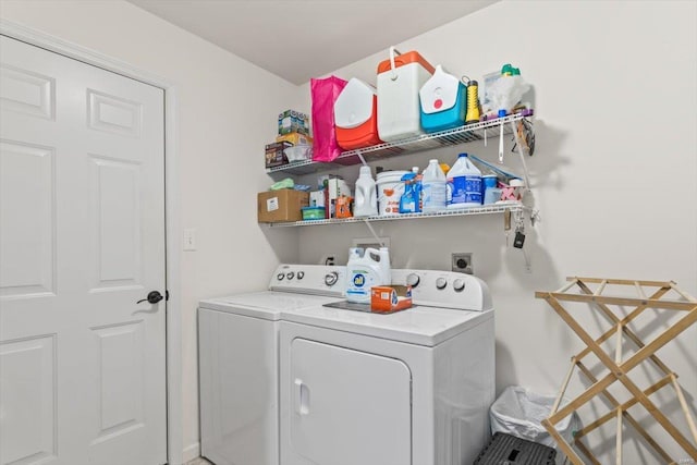 washroom with washing machine and clothes dryer