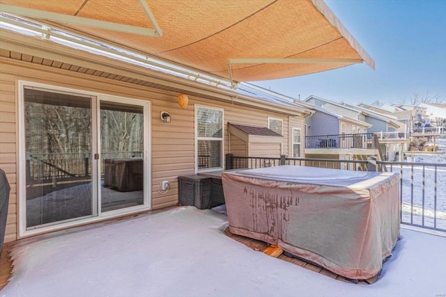 view of patio featuring a jacuzzi and a balcony