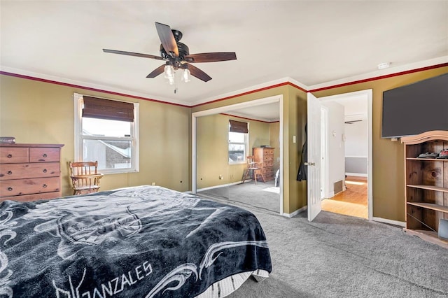 carpeted bedroom featuring ceiling fan and ornamental molding