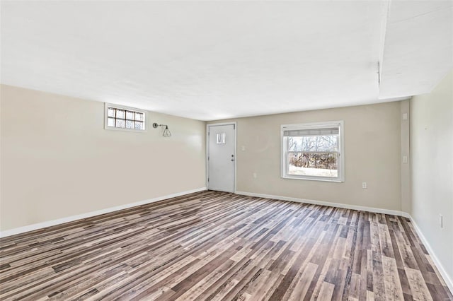 spare room featuring a wealth of natural light and hardwood / wood-style floors