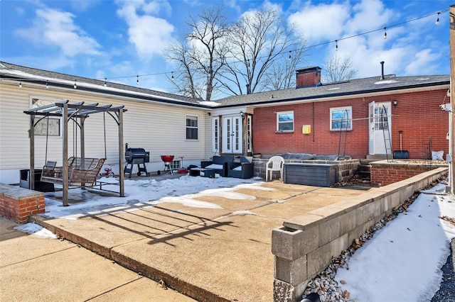 snow covered property with a pergola