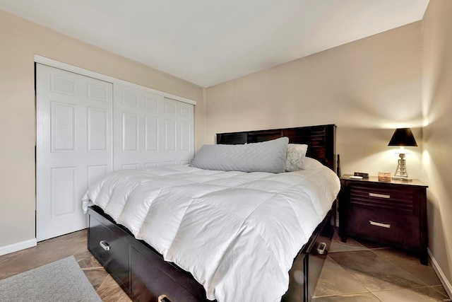 tiled bedroom with a closet