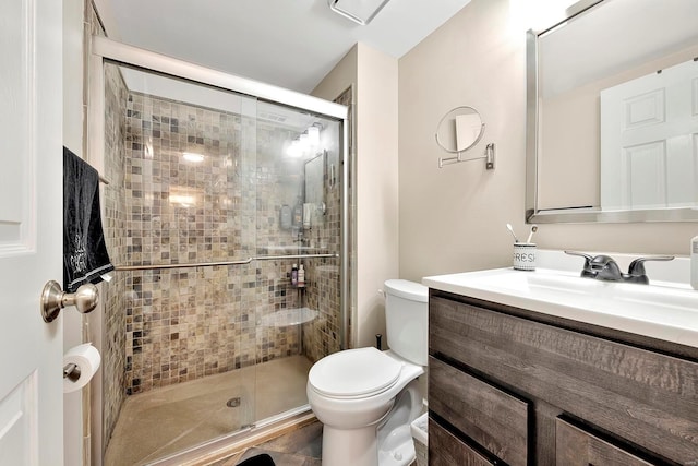 bathroom featuring walk in shower, vanity, and toilet