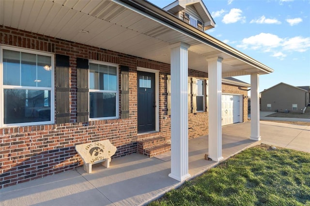 view of patio / terrace featuring a garage and covered porch