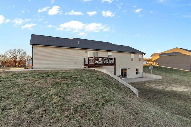 back of property featuring a wooden deck, a yard, and a patio area