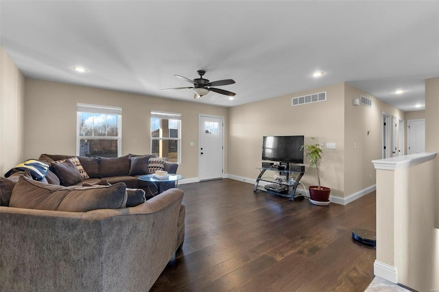 living room featuring ceiling fan and dark hardwood / wood-style flooring