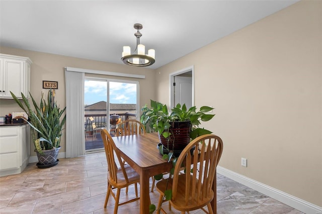 dining area featuring a notable chandelier