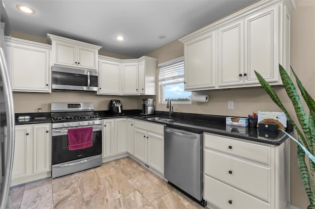 kitchen with white cabinetry, sink, and appliances with stainless steel finishes