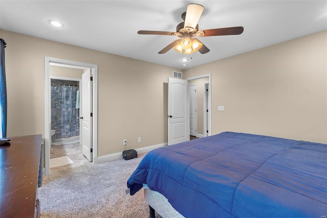 carpeted bedroom with ceiling fan and ensuite bath