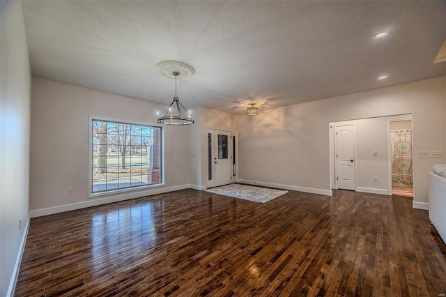 interior space featuring dark hardwood / wood-style flooring and a notable chandelier