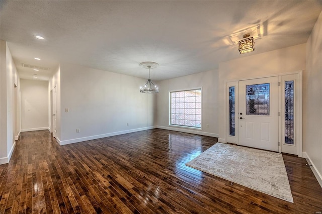 entrance foyer with a chandelier and dark hardwood / wood-style flooring