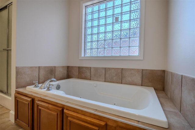 bathroom featuring tile patterned floors, shower with separate bathtub, and a wealth of natural light